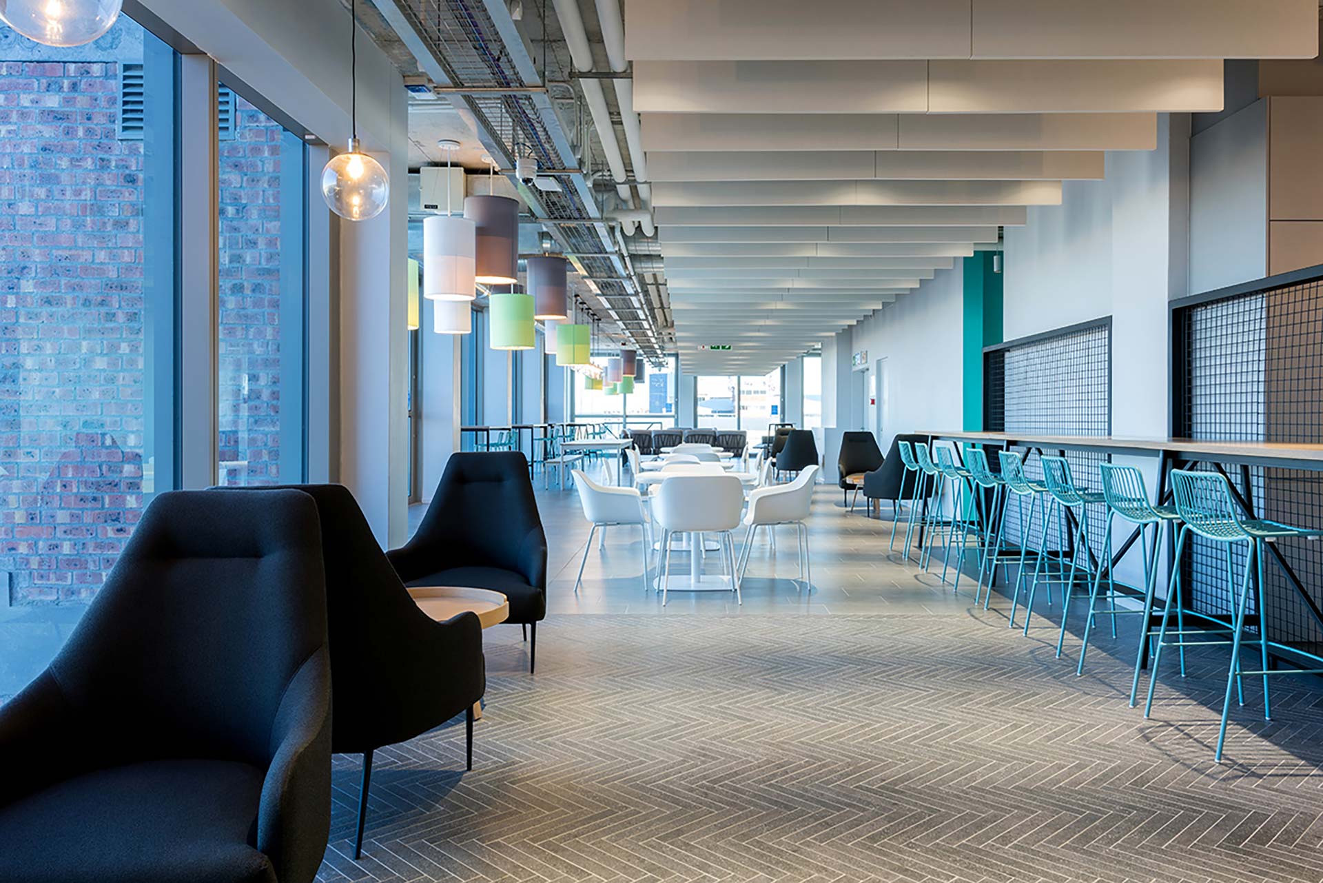 Open-plan office with canteen area and bar stools in 2U workspace in Cape Town