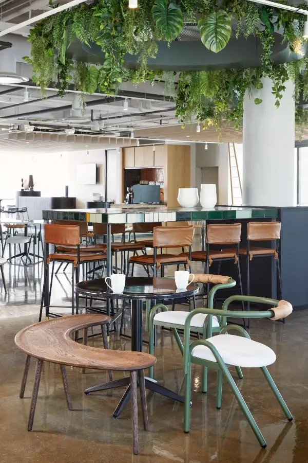Canteen area with curved wooden bench and bar stools in BCG office