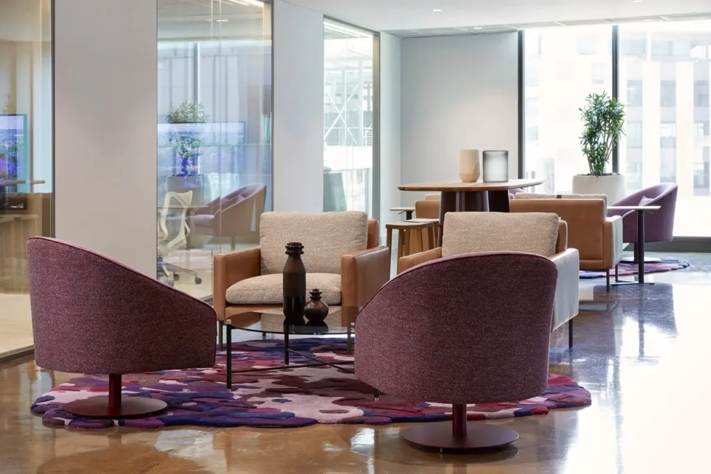 Informal meeting area with cushioned chairs and rugs in BCG office
