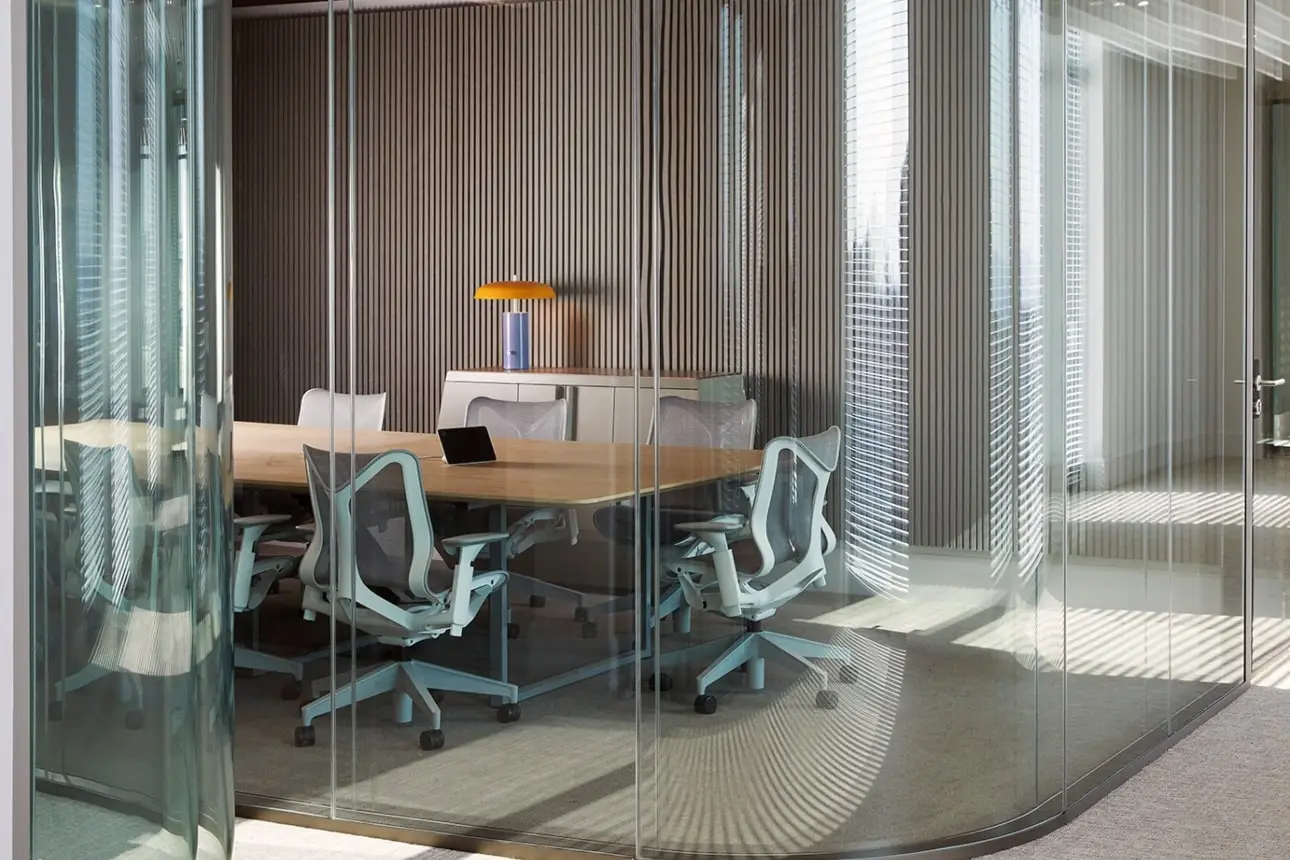 Glass private meeting room with wooden panels in BCG office