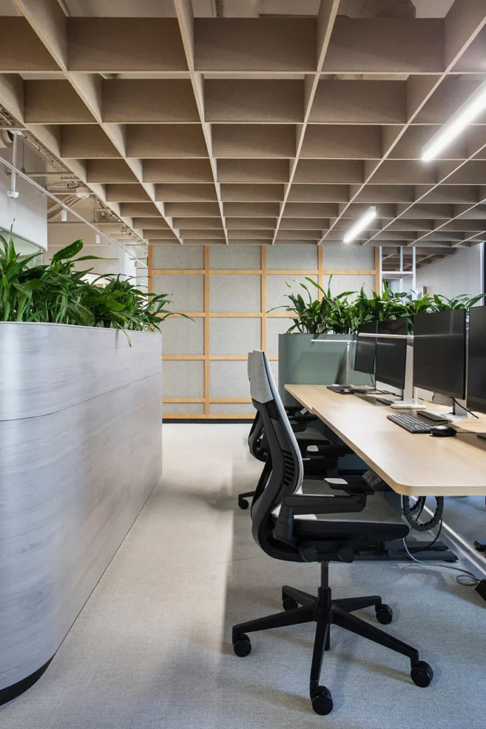 Workspace with ergonomic office chairs and wooden ceiling detail in European Investment Bank office in Johannesburg