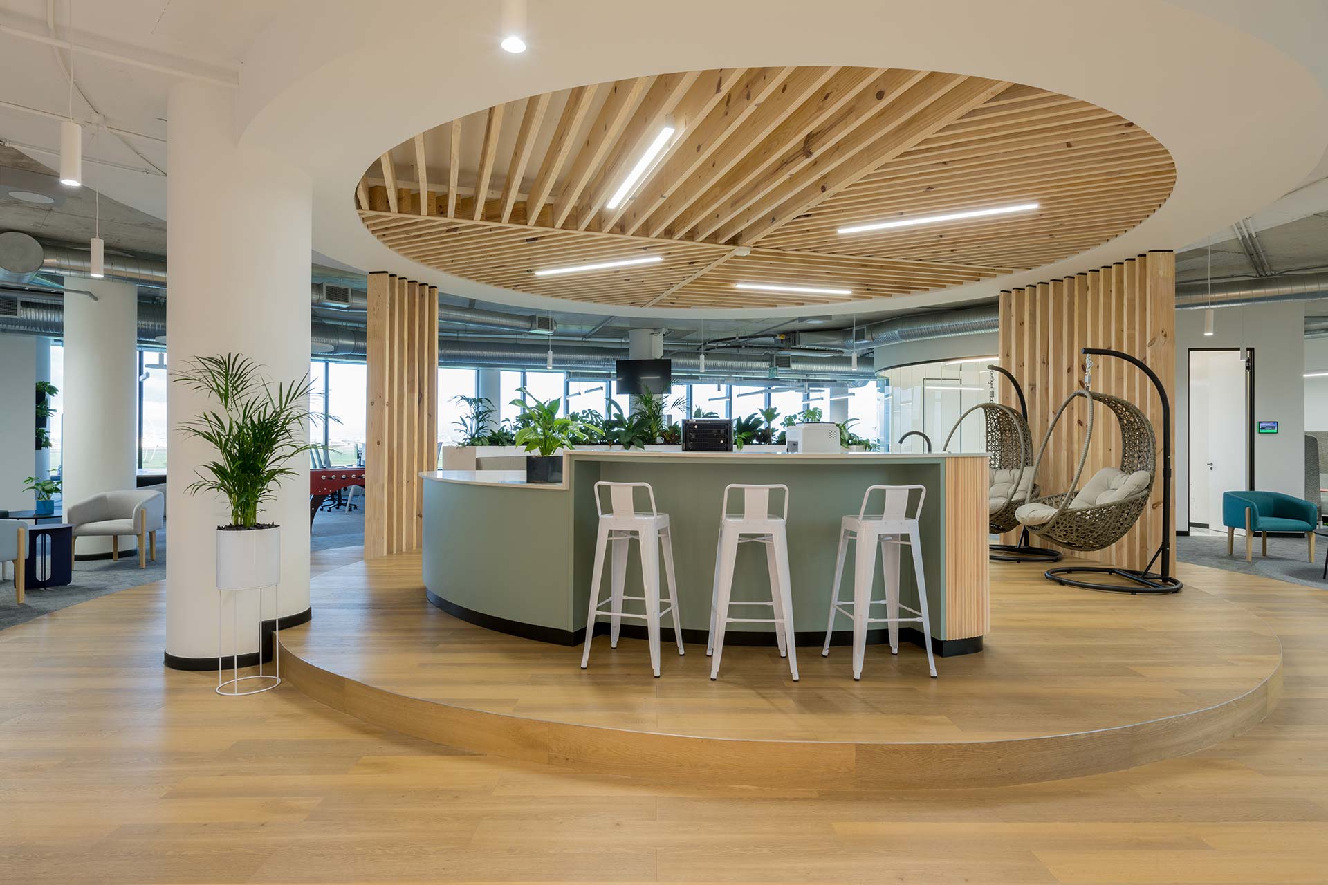 The new impact offices in cape town feature an open collaboration hub with high chairs in white metal finish