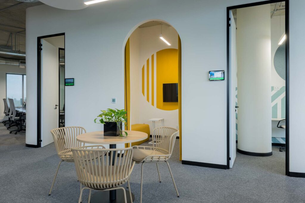 Private meeting rooms for acoustic focus work with phone pods and wicker chairs in open plan office zone