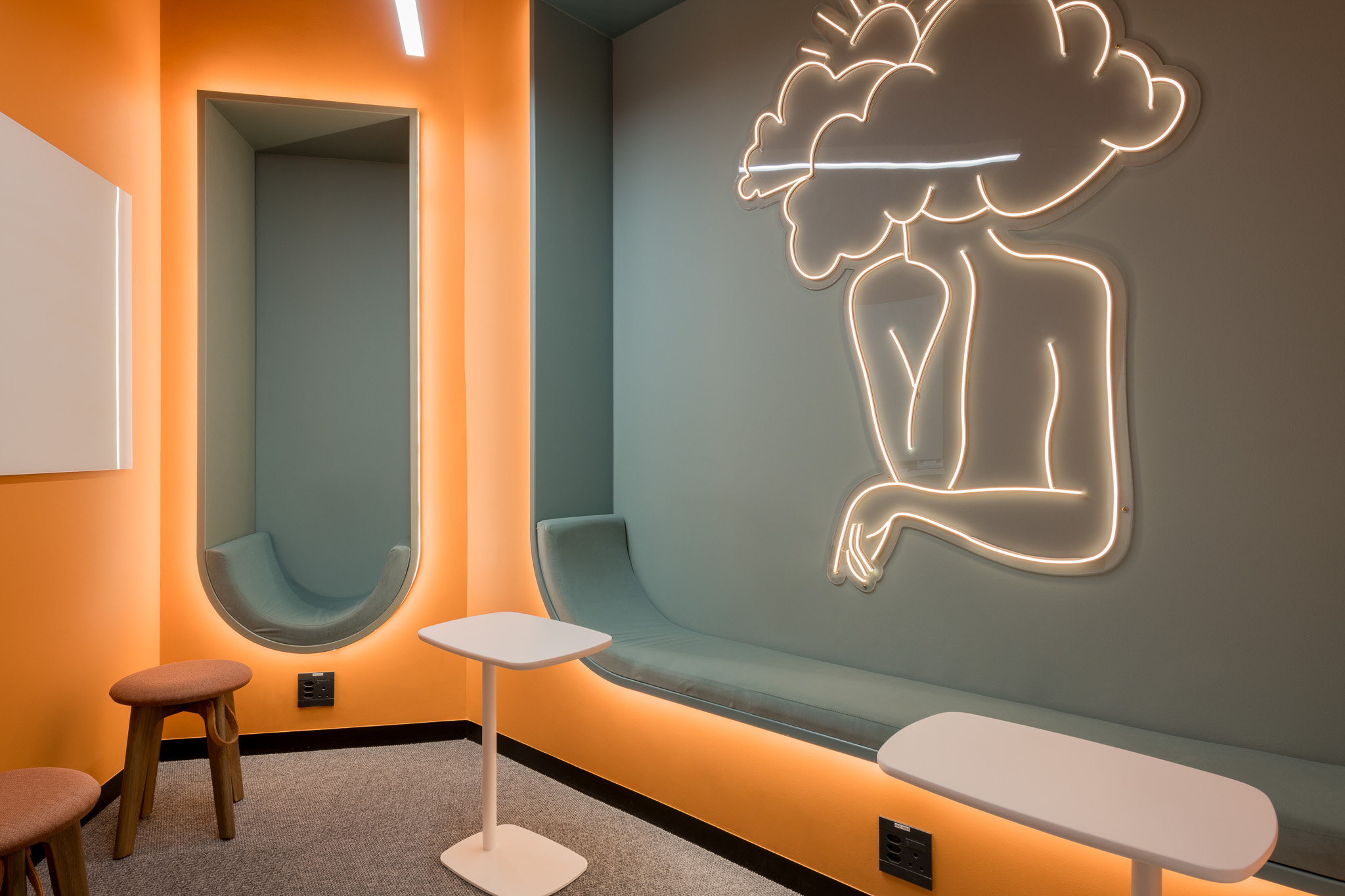 Small focus room with LED lighting and wall art in Impact office in Cape Town