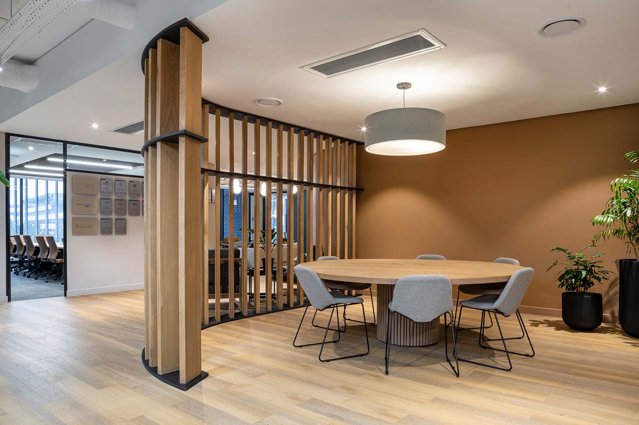 Ergonomic office furniture with wooden panel walls in Inspired Evolution office in Cape Town