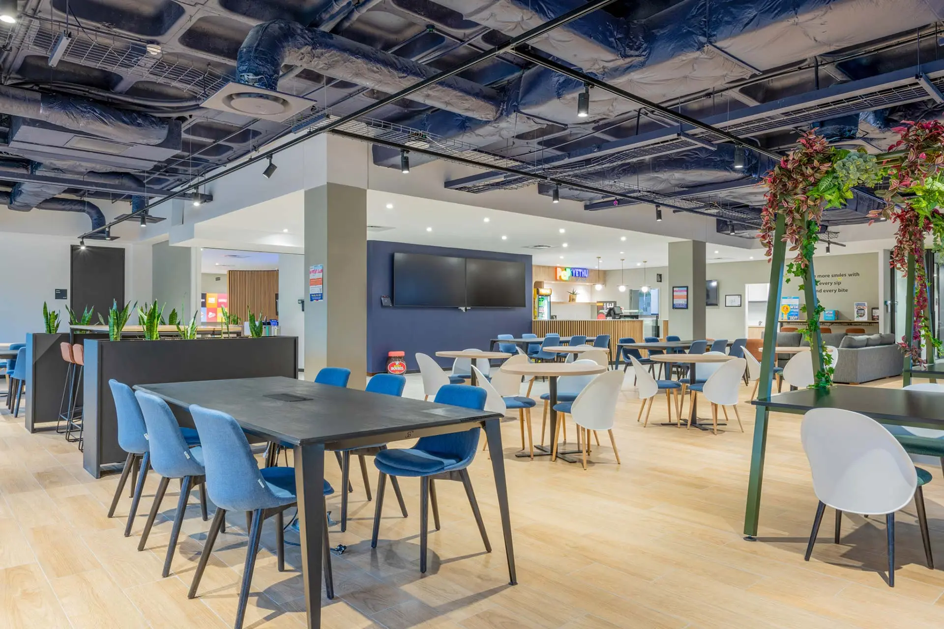 Open plan canteen area with TV and dining tables for PepsiCo in Cape Town