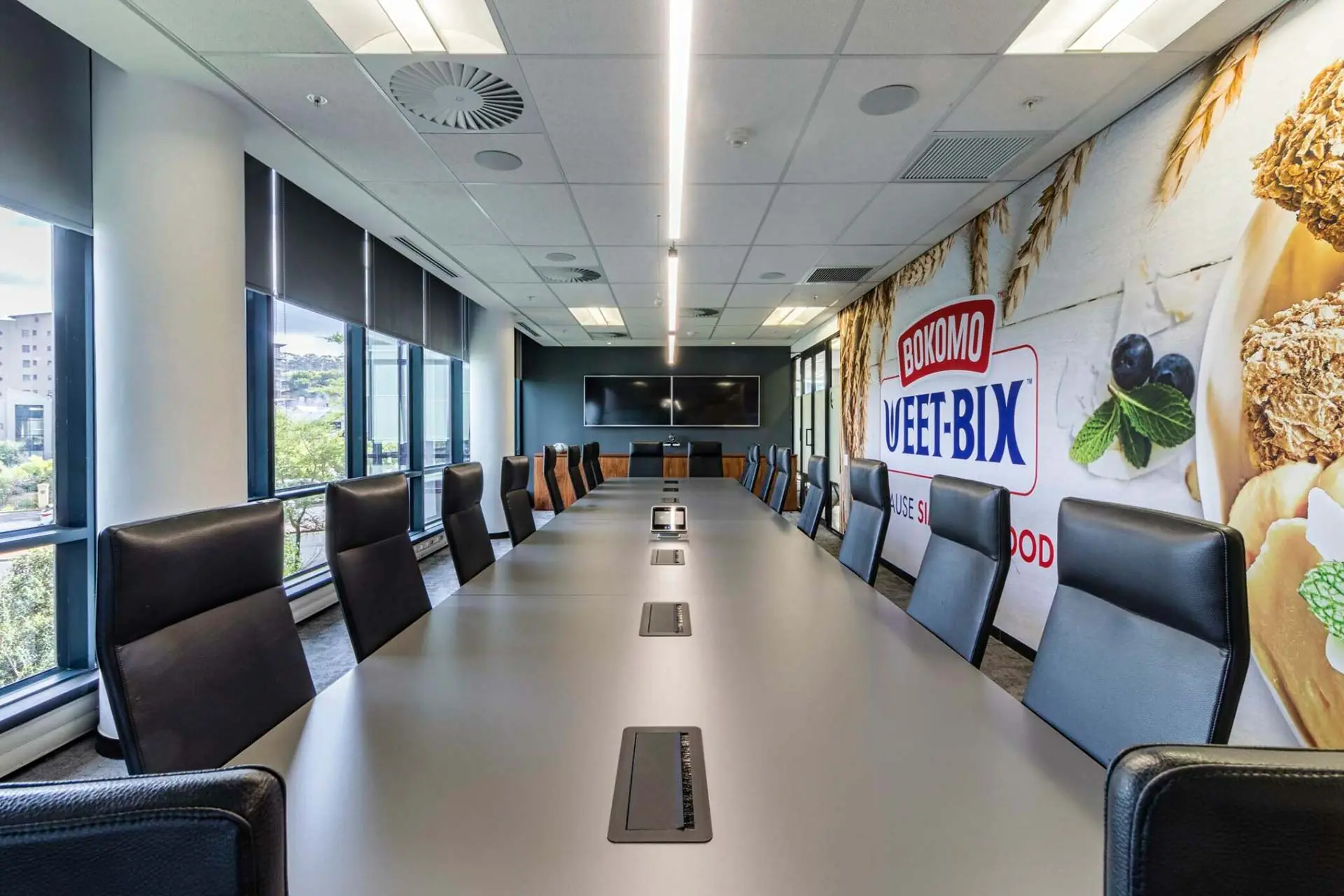 Boardroom with long meeting table and chairs for PepsiCo office furniture in Cape Town