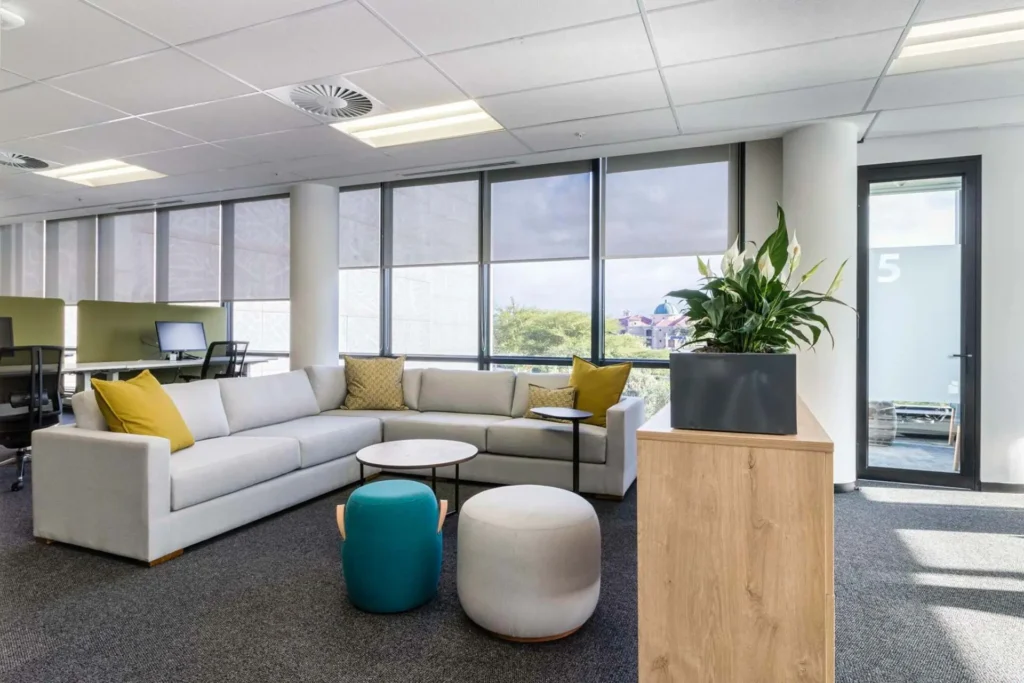 Custom couches and ottomans in lounge area for PepsiCo office furniture in Cape Town