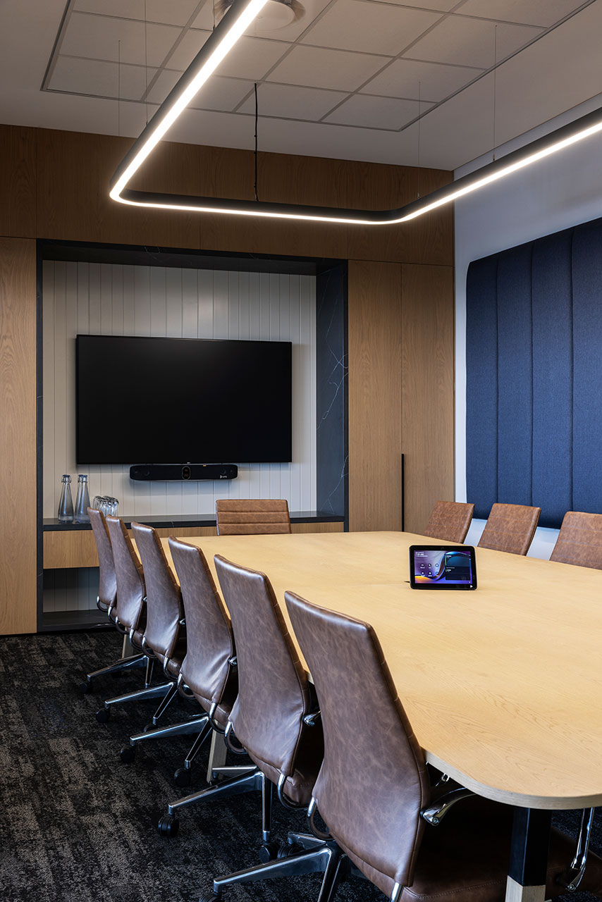 Boardroom with tables, chairs and linear pendant lighting in Pinsent Masons office in Rosebank