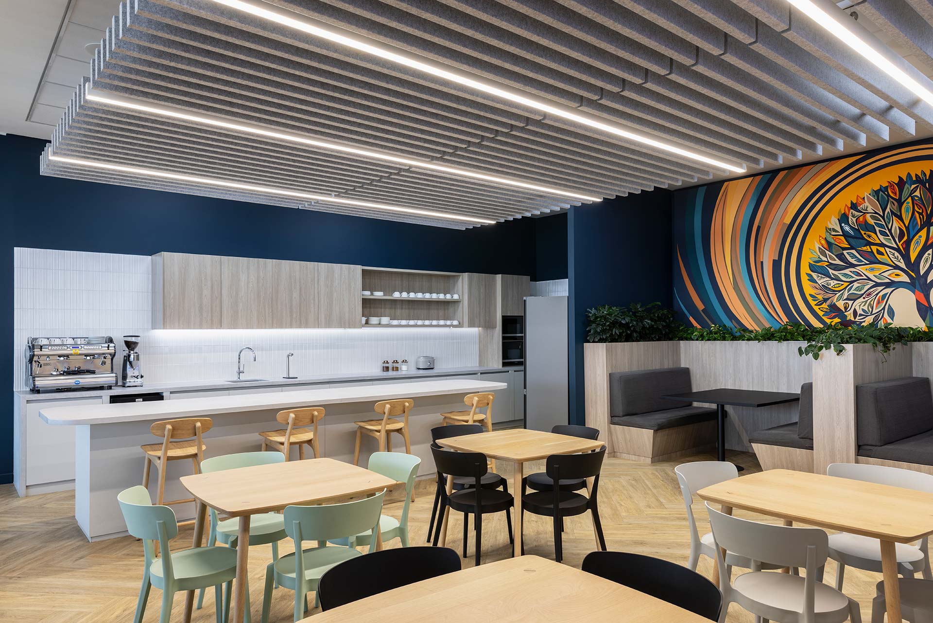 Canteen with tables, chairs and booth seating in Pinsent Masons workspace in Rosebank