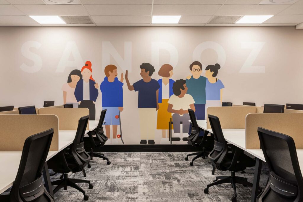 Office desks with wall divider and wall art in Sandoz workspace in Johannesburg