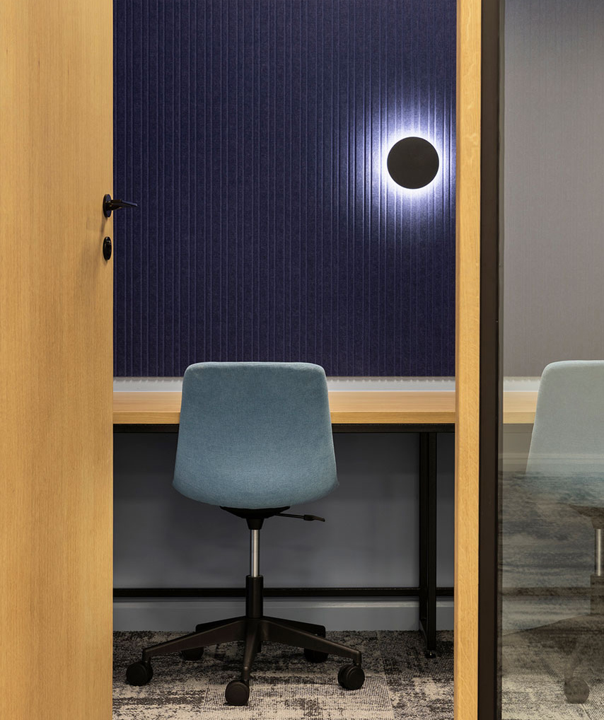 Private room with cushioned chair and feature lighting in Sandoz office in Johannesburg