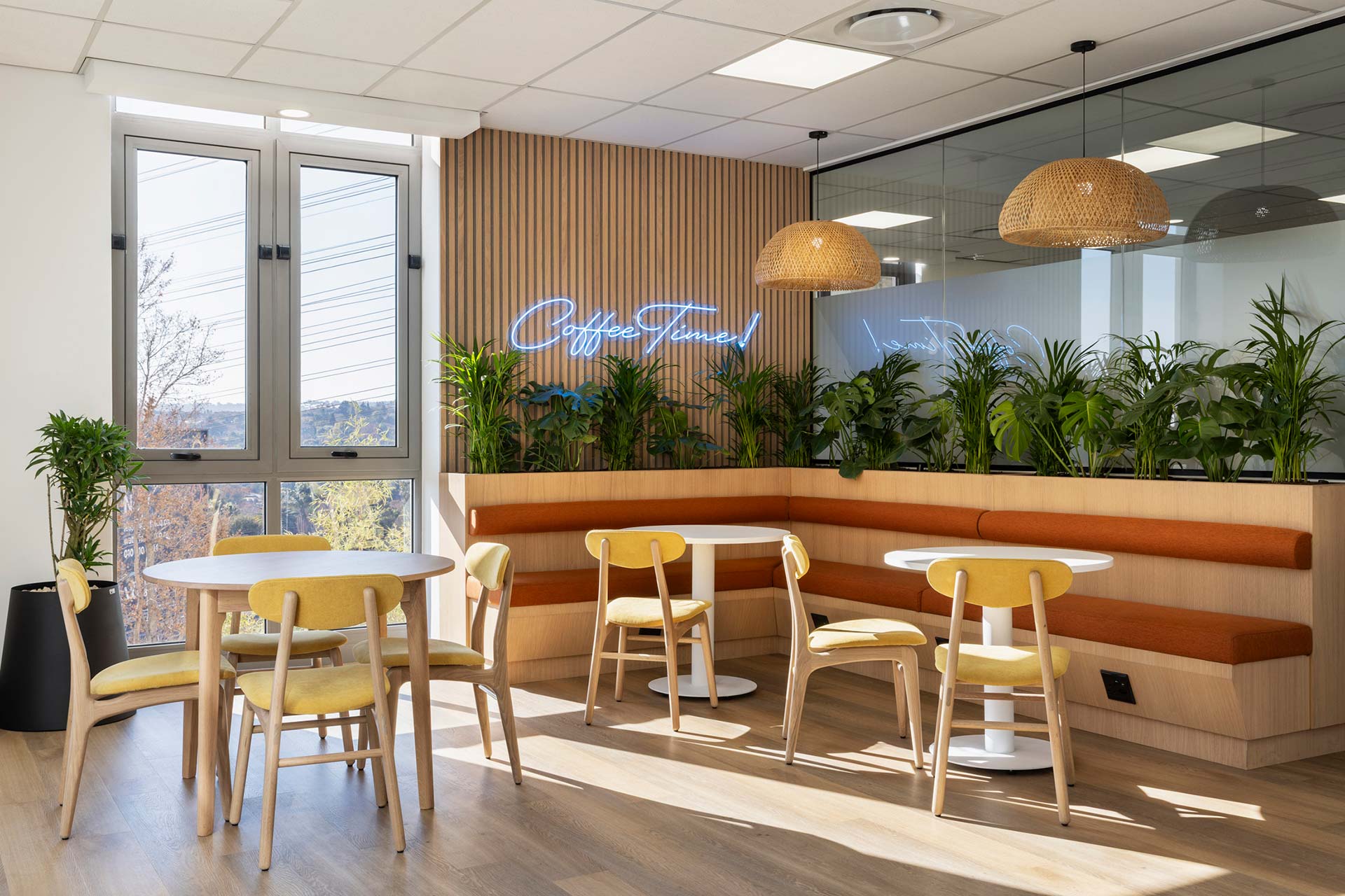 Office canteen with cushioned banquette seating in Sandoz workspace in Johannesburg