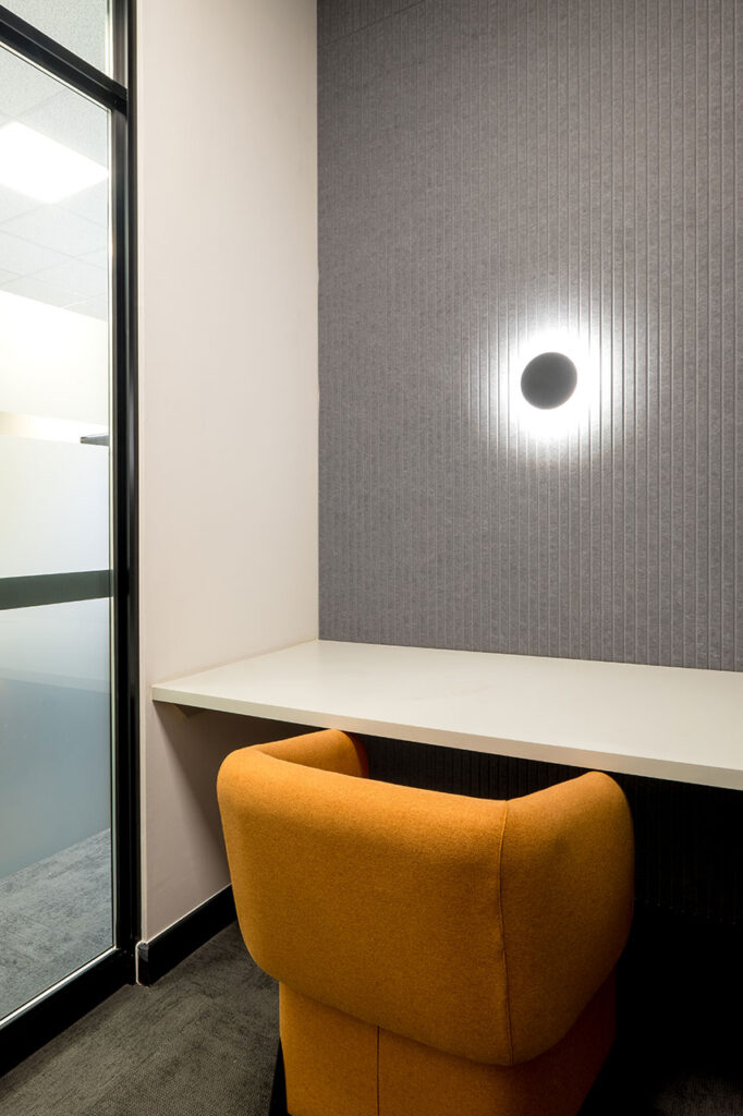 Private room with orange chair and wall light in Shield Chemicals office in Johannesburg
