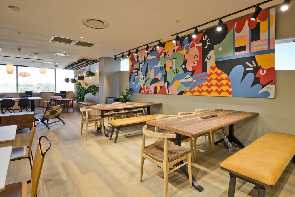 P&G South Africa modern canteen with wooden tables and chairs, artwork and contemporary interior design