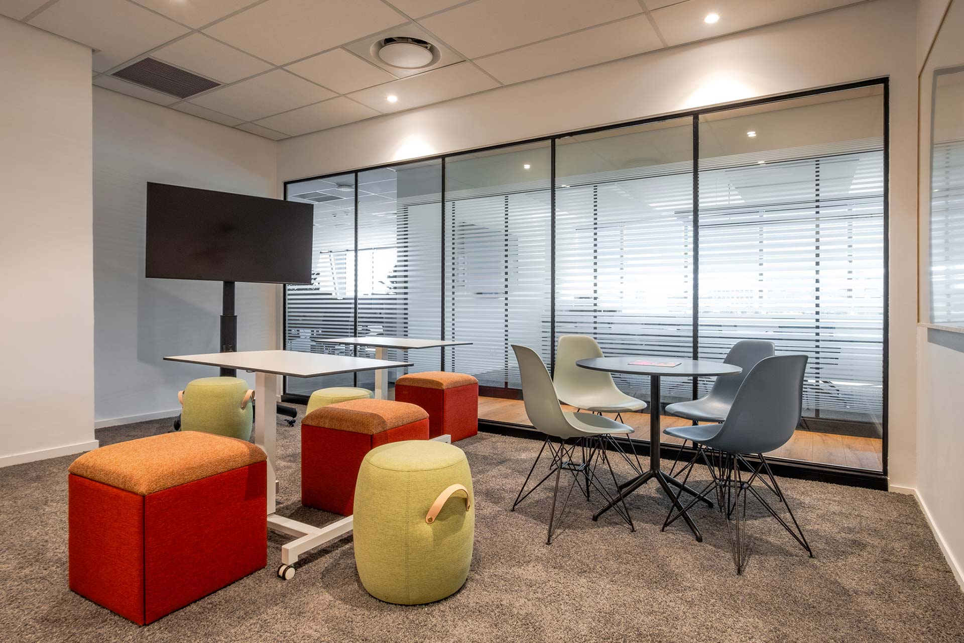 swiss re sandton breakout meeting room with video and ottomans