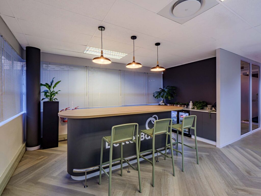 BetterBond Durban office kitchenette featuring high custom bar furniture, bar stools and planters supplied through Design Colab's furniture procurement services
