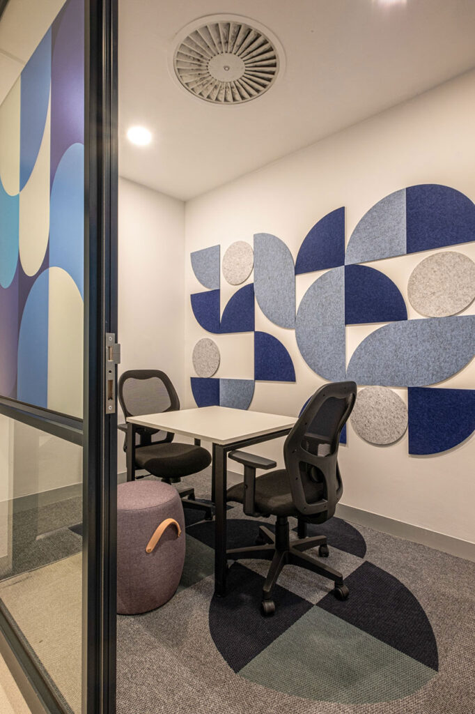 Eduvos Pretoria private training pod with a custom desk and colourful acoustic panels for focused student learning