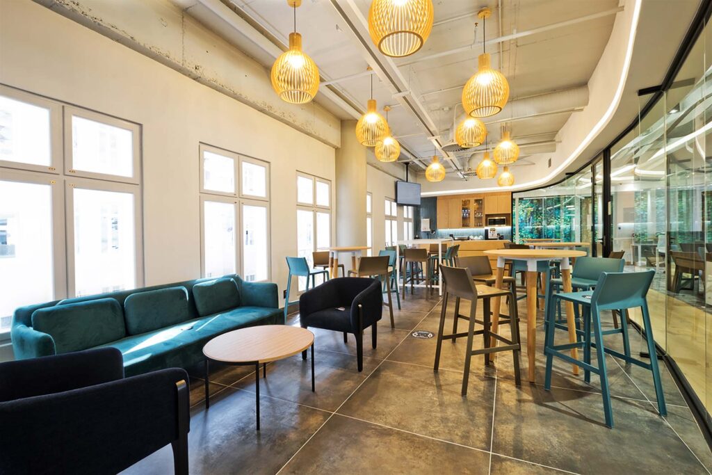 Liberty Sandton commercial office canteen with comfortable contemporary furniture, a bartool mixed-seating area, and lighting supplied by Design Colab.