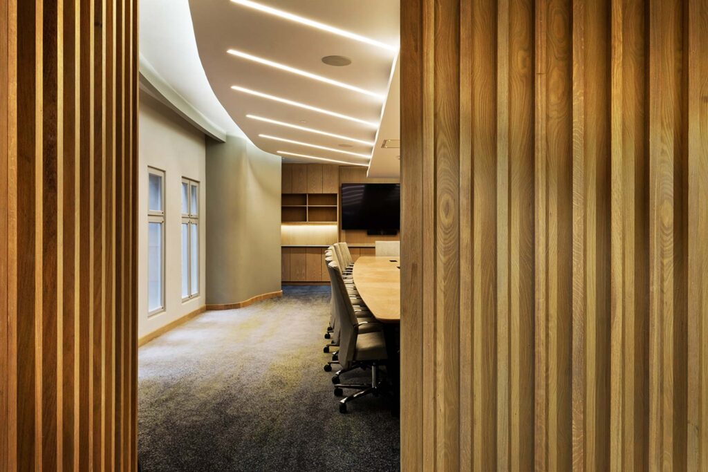 Liberty Sandton commercial office boardroom featuring high-quality office chairs, a contemporary wooden boardroom table and integrated storage supplied by Design Colab