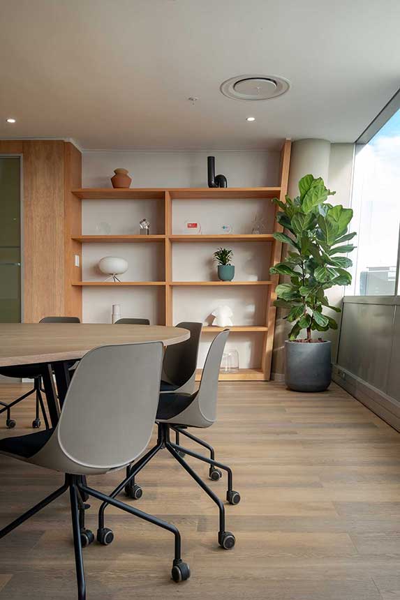 Procter & Gamble South Africa commercial office with modern chairs, a custom round wooden table and contemporary wooden storage shelving