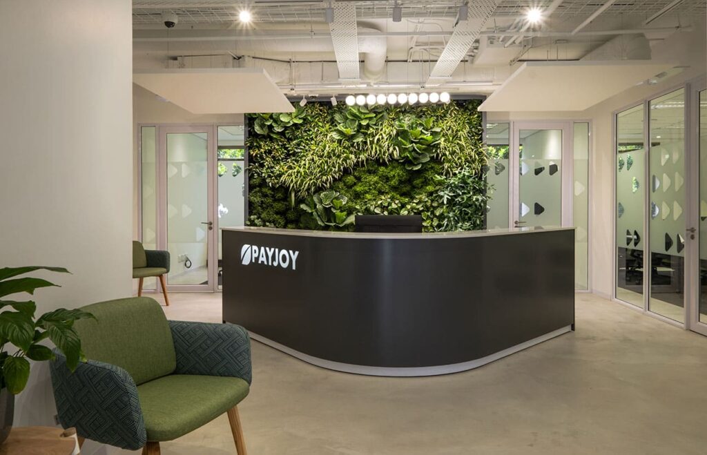 PayJoy Johannesburg commercial office reception with contemporary business furniture and a green feature wall
