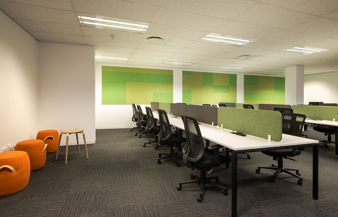 PayJoy Johannesburg commercial office with contemporary desks, acoustic panels, ottomans, and furniture procured in branded colors for the workplace