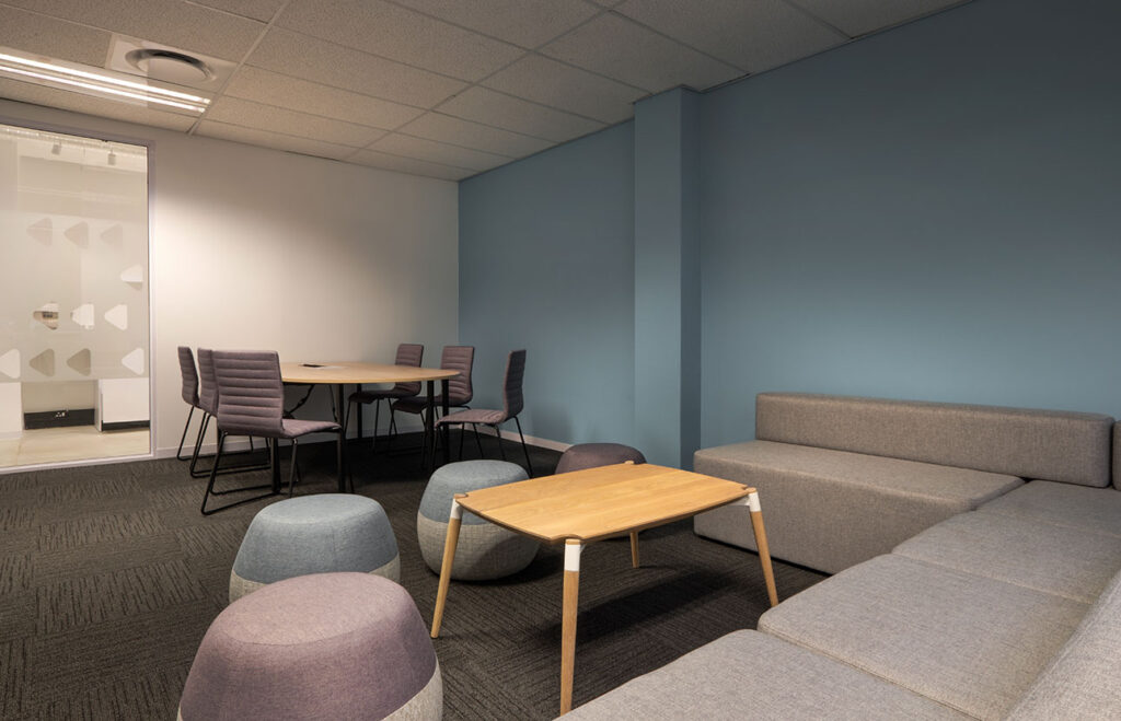 PayJoy Johannesburg office meeting area with contemporary tables, chairs and custom bench seating