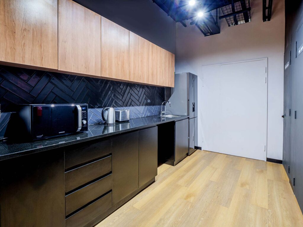 Sportradar office kitchen with high-quality commercial cabinetry, custom finishes and FF&E furniture solutions