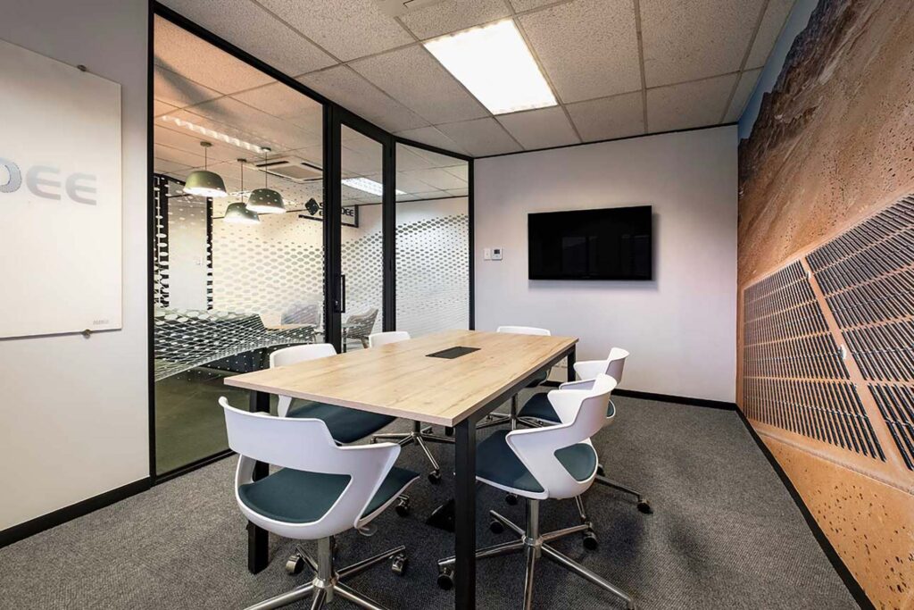 Sturdee Energy South Africa office refurbishment with FF&E furniture and a modern conference room featuring high-tech meeting solutions