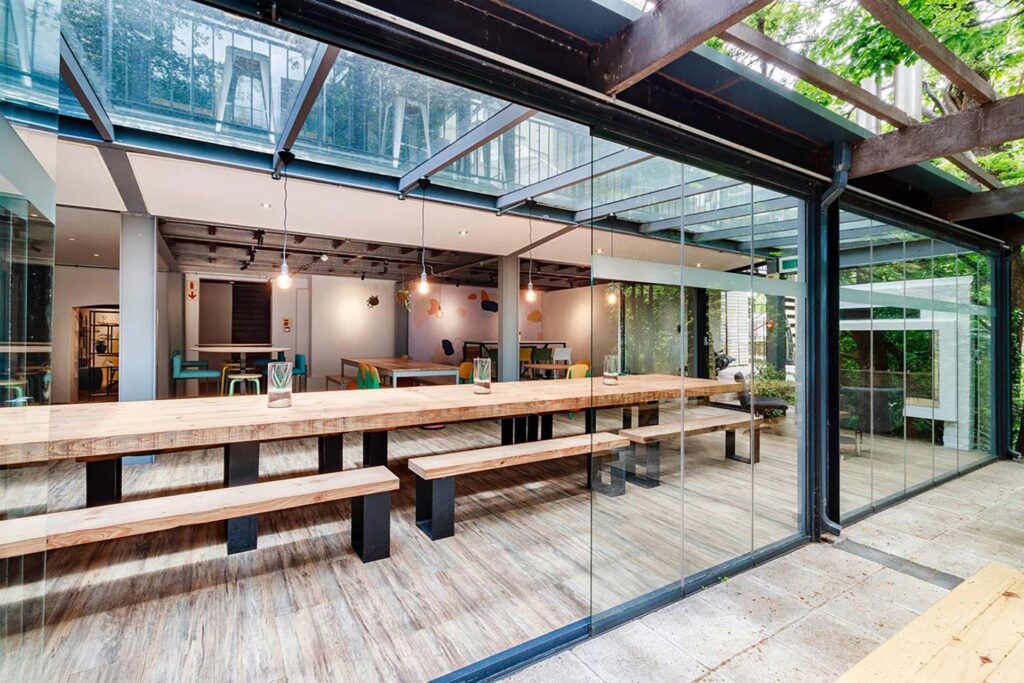 Valenture Cape Town campus with custom long wooden benches and outdoor tables sourced by Design Colab