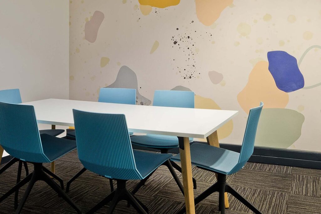 Valenture Johannesburg college meeting room with bold colours, a modern meeting table and contemporary chairs, supplied through Design Colab’s FF&E procurement services in South Africa