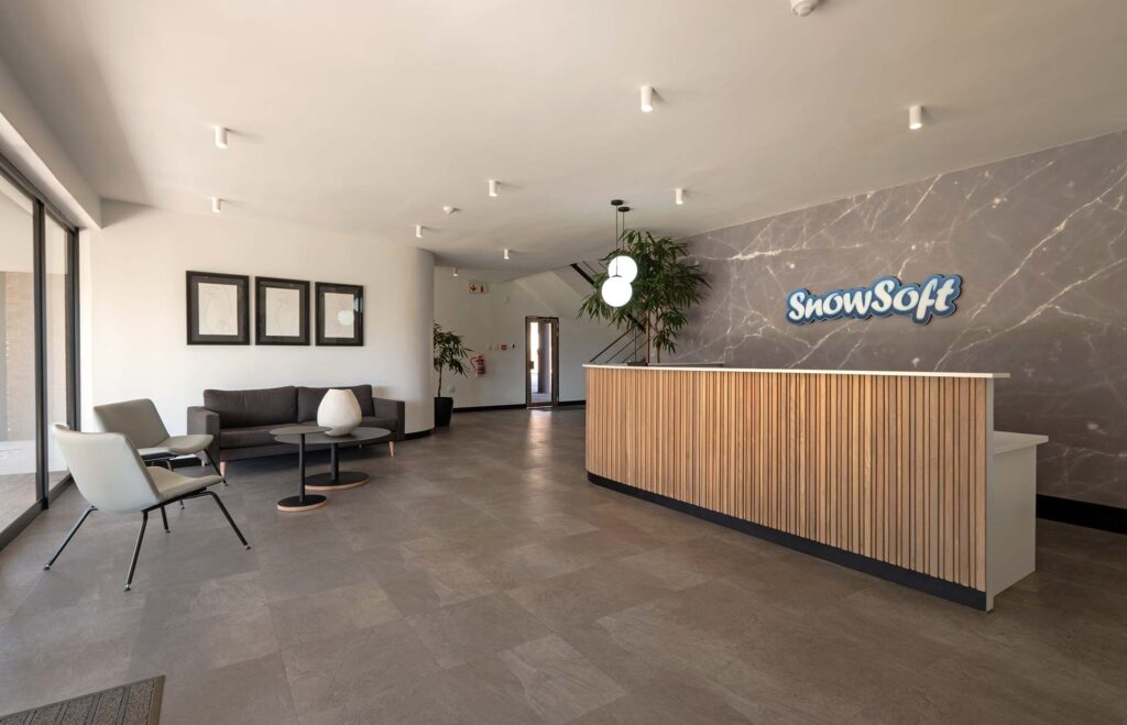 Snowsoft commercial reception and lounge with custom reception desk and statement seating, showcasing bespoke workplace furniture design