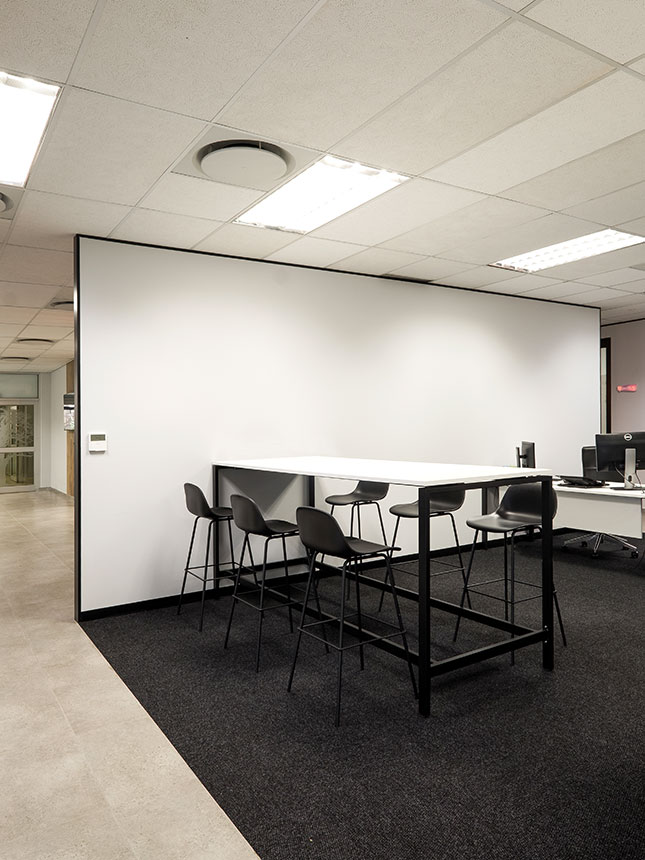 Atlas Copco Johannesburg collaborative workspace with black bar stools and high table for meetings and work