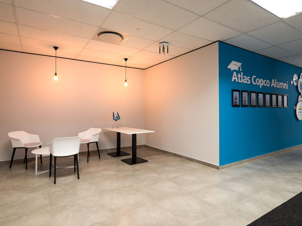 Atlas Copco Johannesburg office reception with white visitor chairs, coffee table and reception desk