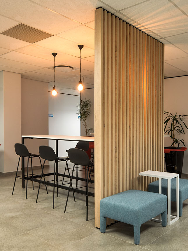 Atlas Copco South Africa collaborative workspace with wooden partition, laptop table and high bar table with stools