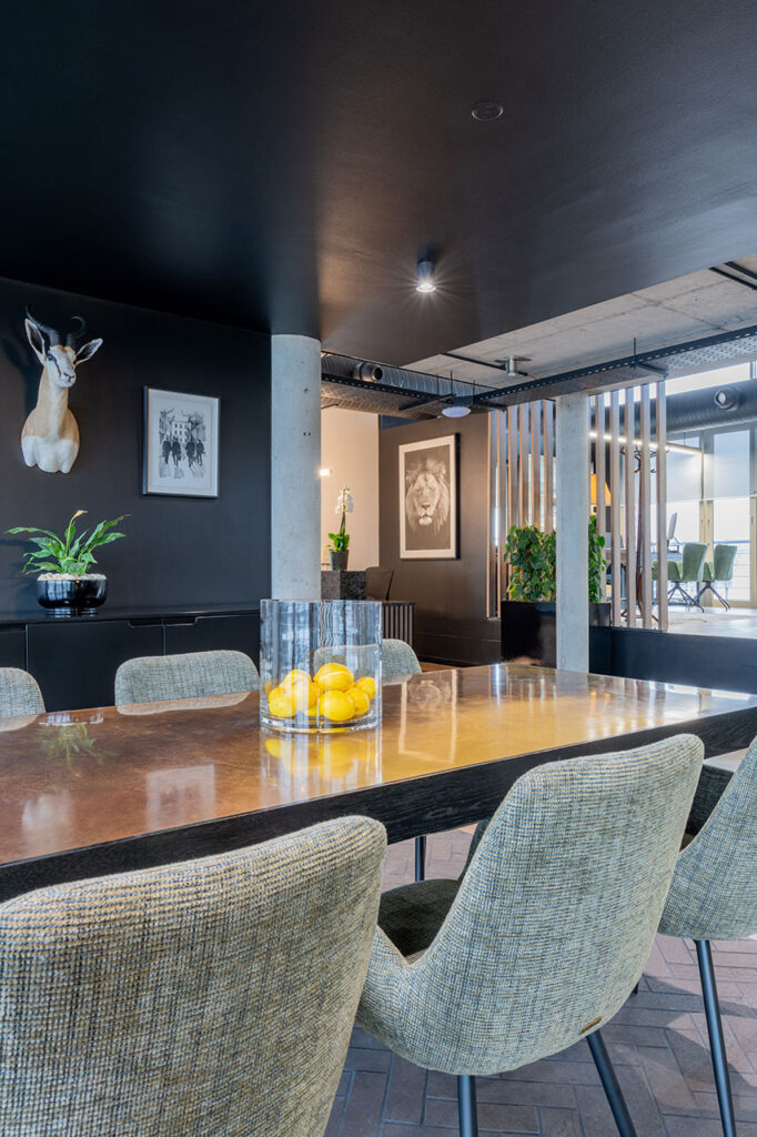 Lion Capital Cape Town large meeting room with varnished timber table and custom soft fabric chairs, showcasing luxury FF&E procurement