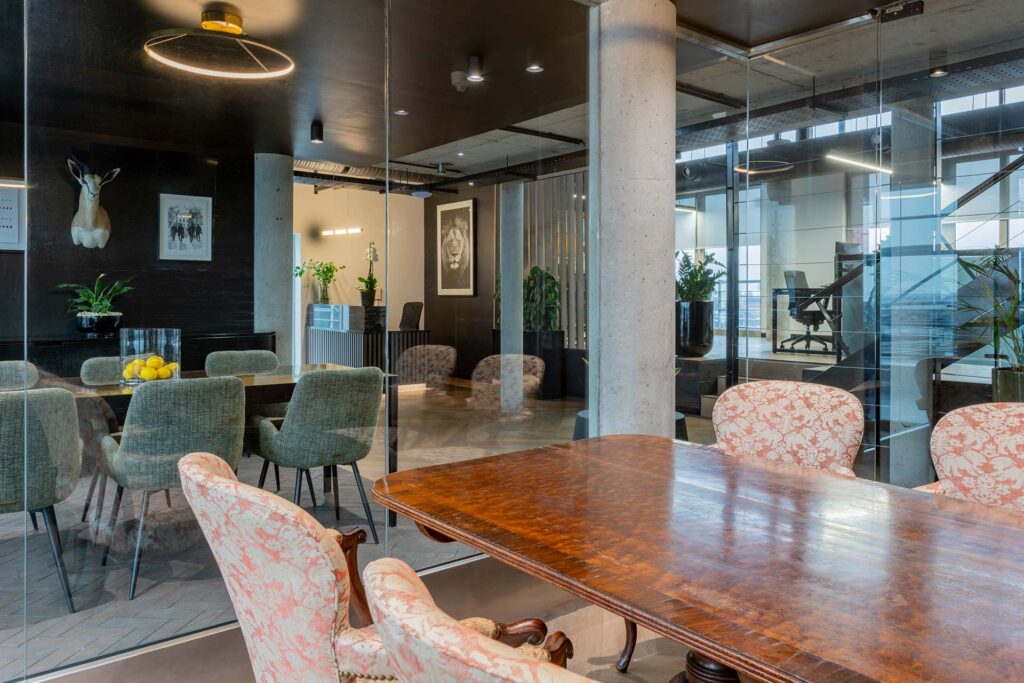 Lion Capital Cape Town meeting room with custom fabric chairs and ornate timber tables, showcasing luxury corporate furniture procurement
