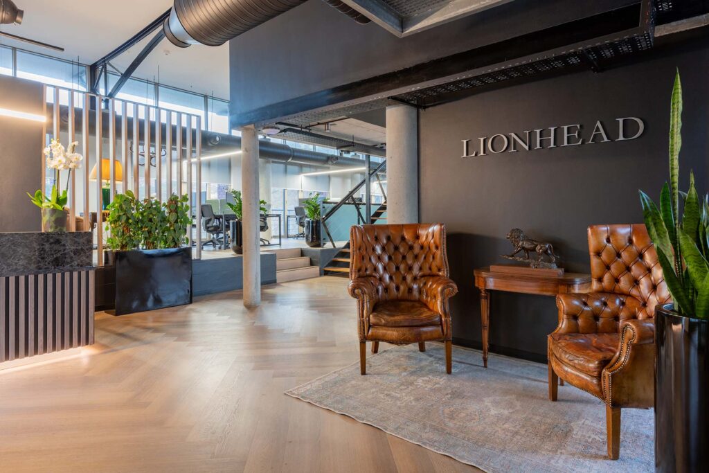 Lion Capital Cape Town reception area with luxury tan leather armchairs, showcasing high-end corporate furniture and FF&E procurement