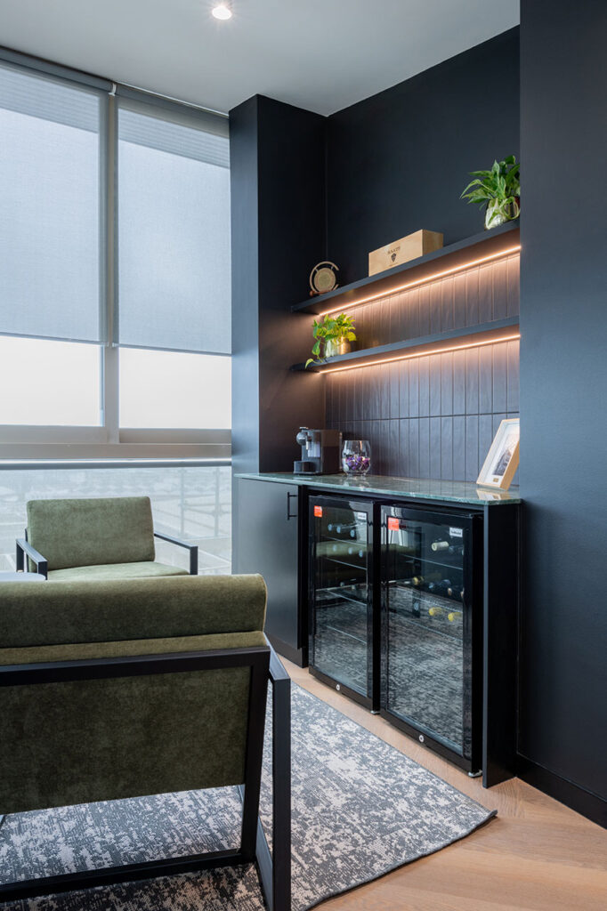Lion Capital Cape Town office canteen bar area with custom cabinetry, open shelving and modern lighting, showcasing luxury FF&E furniture solutions