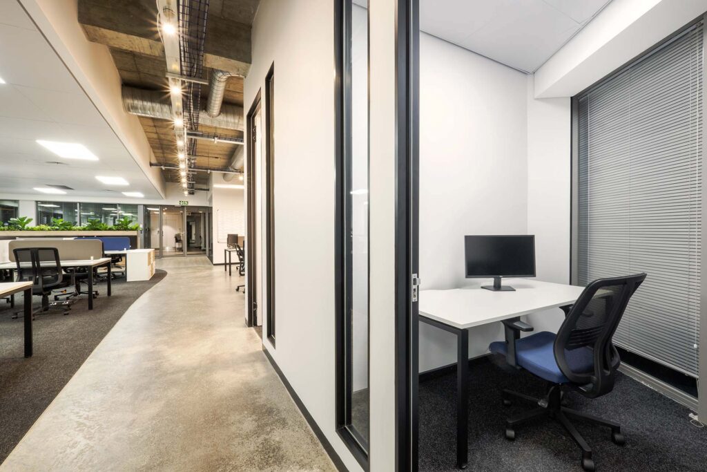 Mazars' open-plan office features high-tech furniture, including a chair and desk for a small acoustic booth.