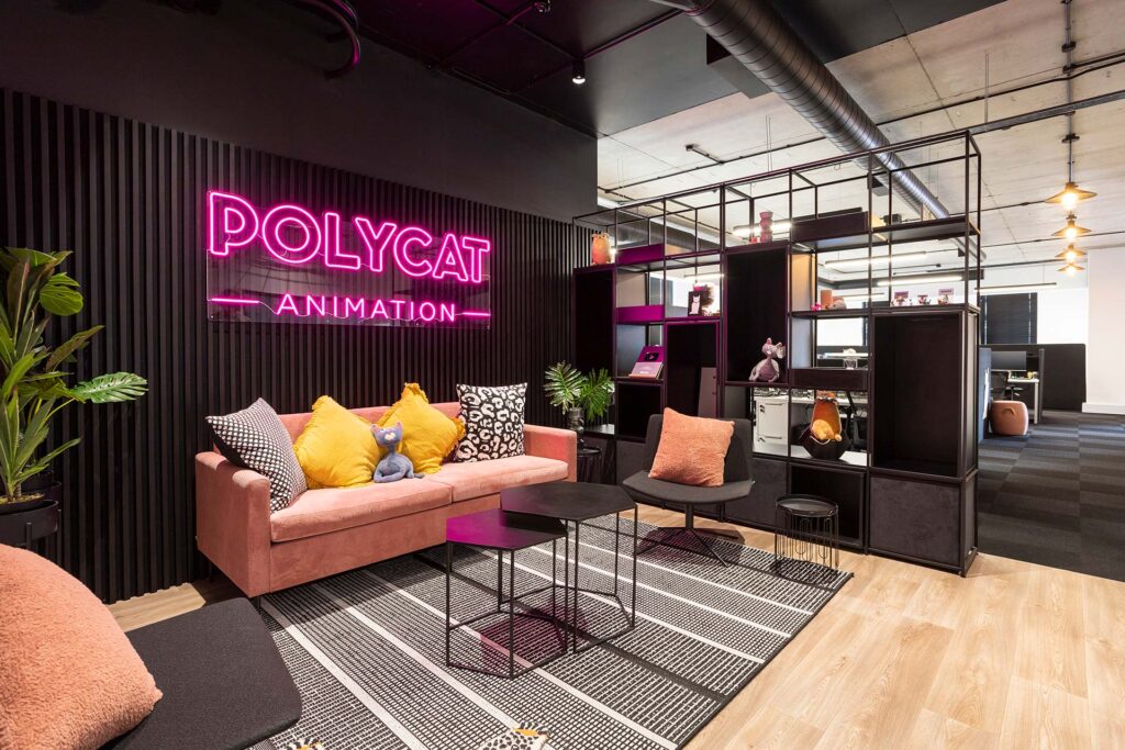Polycat Cape Town creative studio reception with colourful lounge seating, cushions, black coffee tables and storage unit for commercial furniture solutions