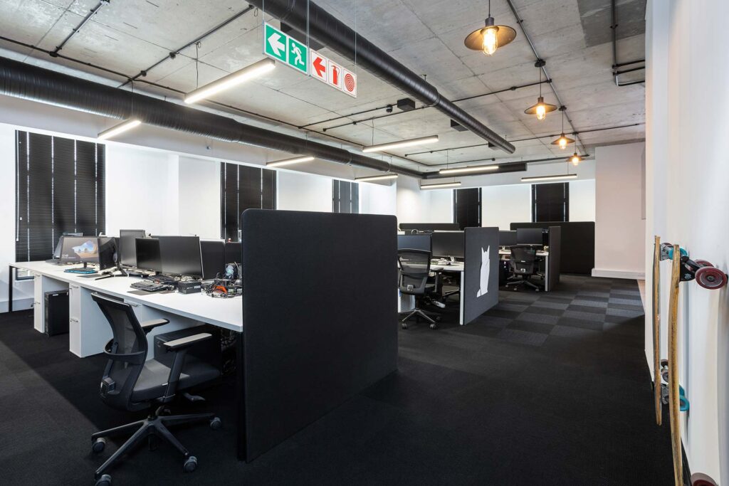 Polycat Cape Town editing studio with modern white open-plan desks and ergonomic office chairs, showcasing workplace furniture procurement