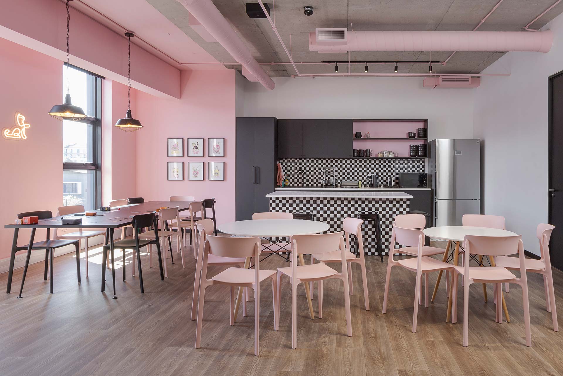 olycat Cape Town canteen with pink, black and white chairs and round white tables, showcasing contemporary workplace furniture procurement