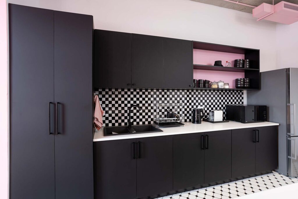 Polycat Cape Town modern kitchenette with black cabinetry, open shelving and contemporary workplace kitchen design