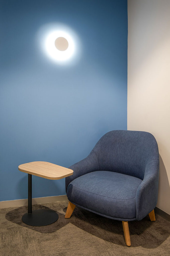 Sanlam Houghton focus room with comfortable armchair and hybrid laptop table, showcasing flexible office furniture