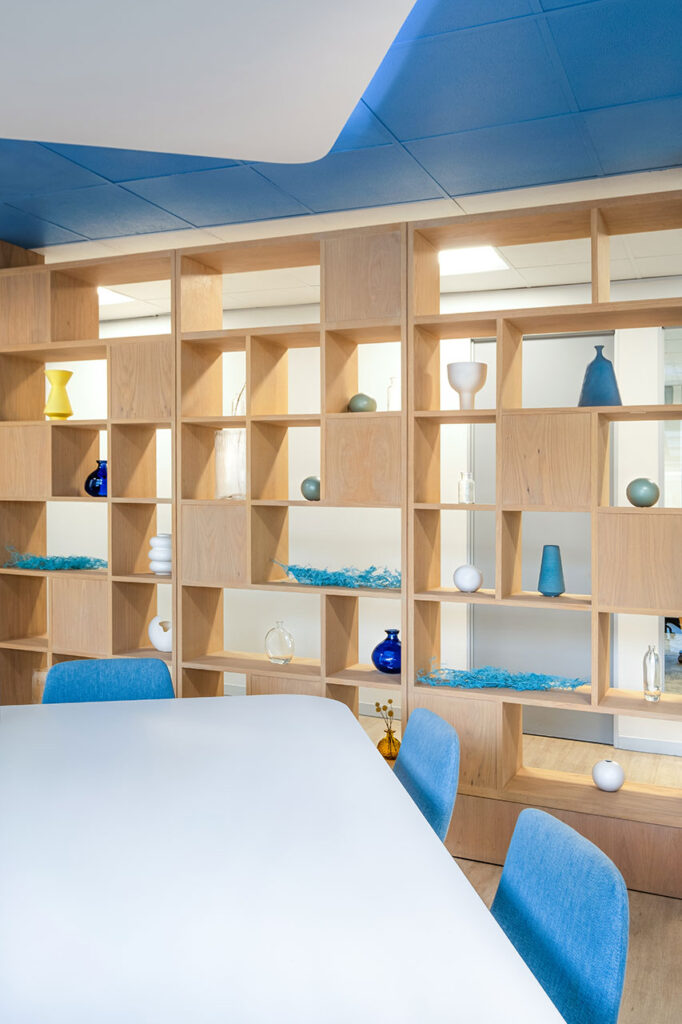 Sanlam Houghton office with custom timber shelving, décor and screening, showcasing bespoke workplace furniture solutionsest joburg financial office furniture installation