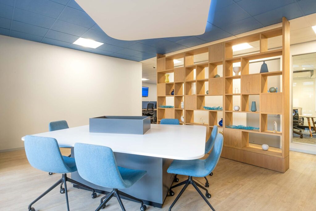Sanlam Houghton open-plan office with coordinated furniture, blue chairs, white table and timber shelving