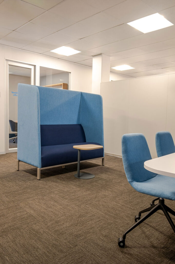 Sanlam Houghton corporate focus area with blue booth seating and laptop table, showcasing flexible workplace furniture