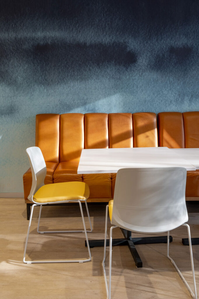 Sanlam Houghton breakout area with modern white furniture and custom tan leather bench seating